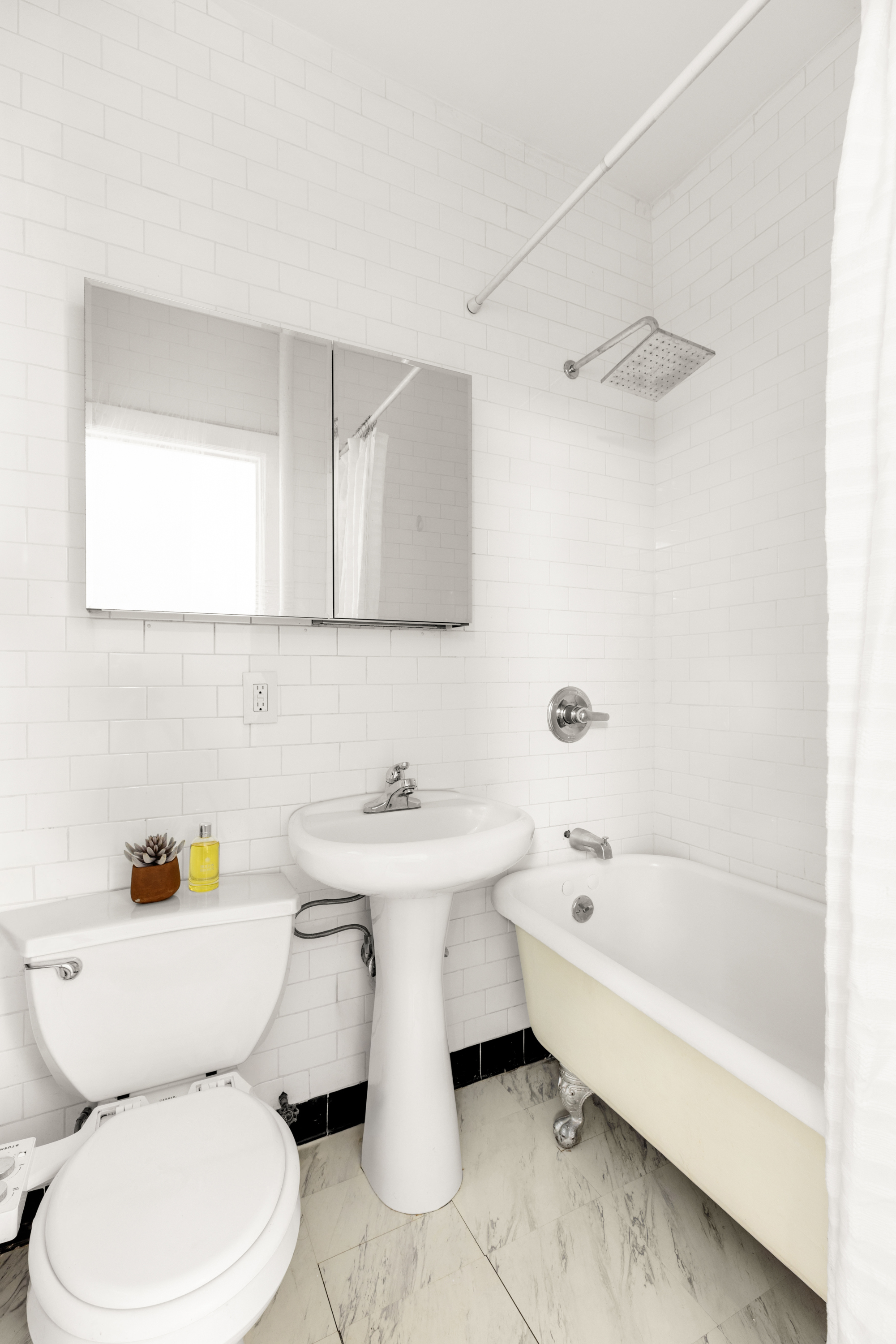 126 East 12th Street, Unit 2C Manhattan, NY 10003 - Photo 7 of 10 a bathroom with a sink toilet and bathtub
