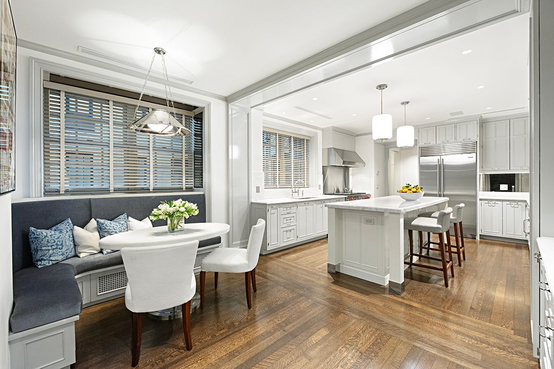 a living room with dining room and kitchen view