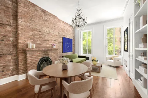 a living room with furniture a chandelier and a fireplace
