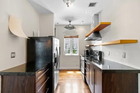 a kitchen with stainless steel appliances a stove a refrigerator and a sink