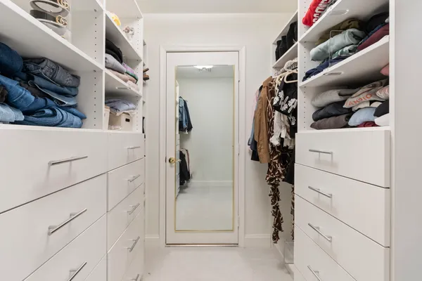 a bathroom with a toilet sink double vanity and mirror