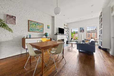 a view of a livingroom with furniture and a flat screen tv