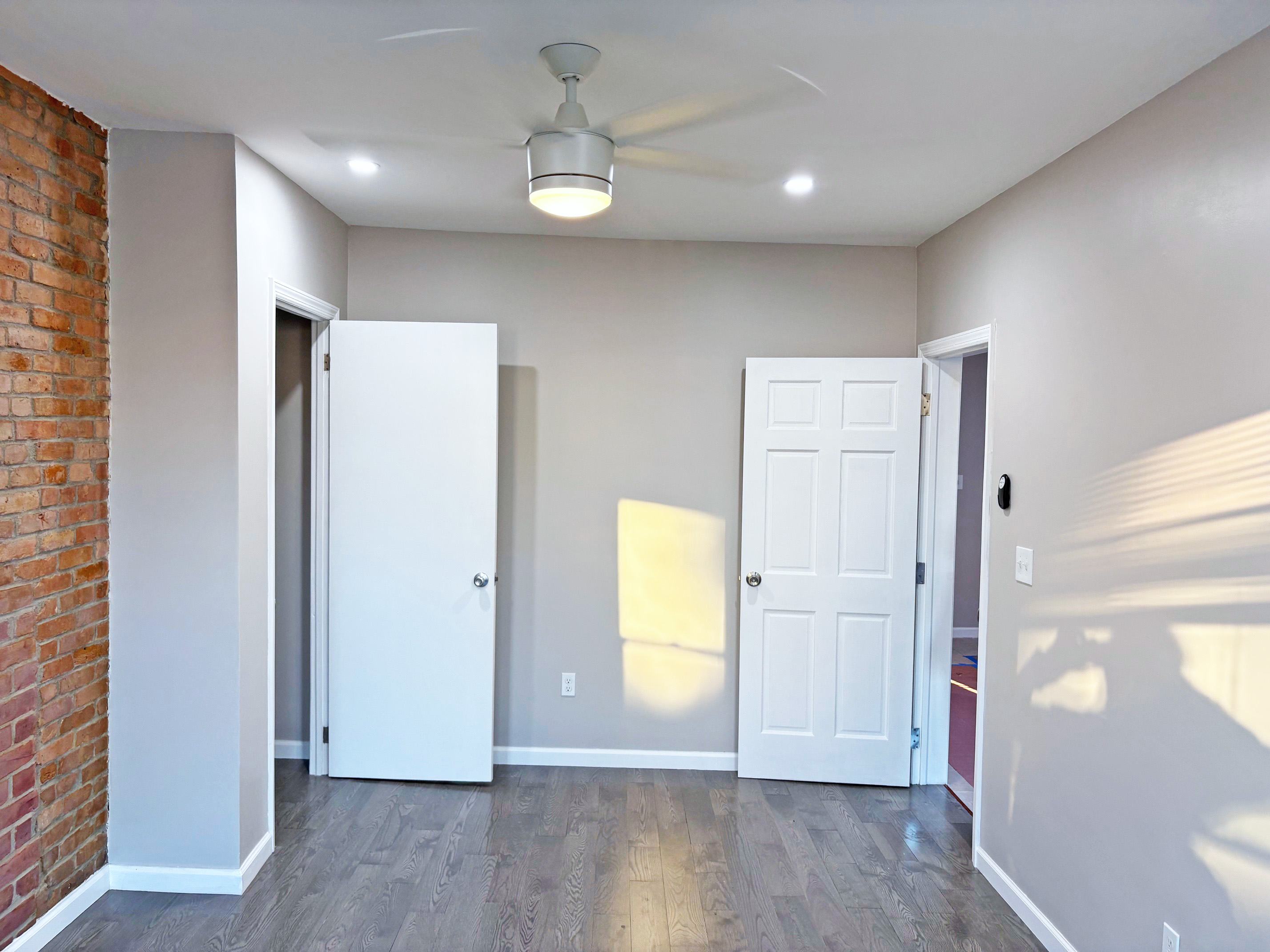 179 Covert Street, Unit 3 Brooklyn, NY 11207 - Photo 4 of 14 an empty room with wooden floor and a window