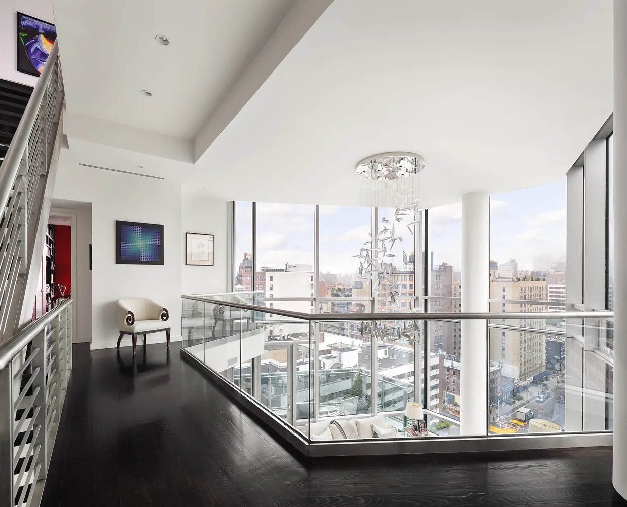 a view of a living room with furniture and floor to ceiling windows