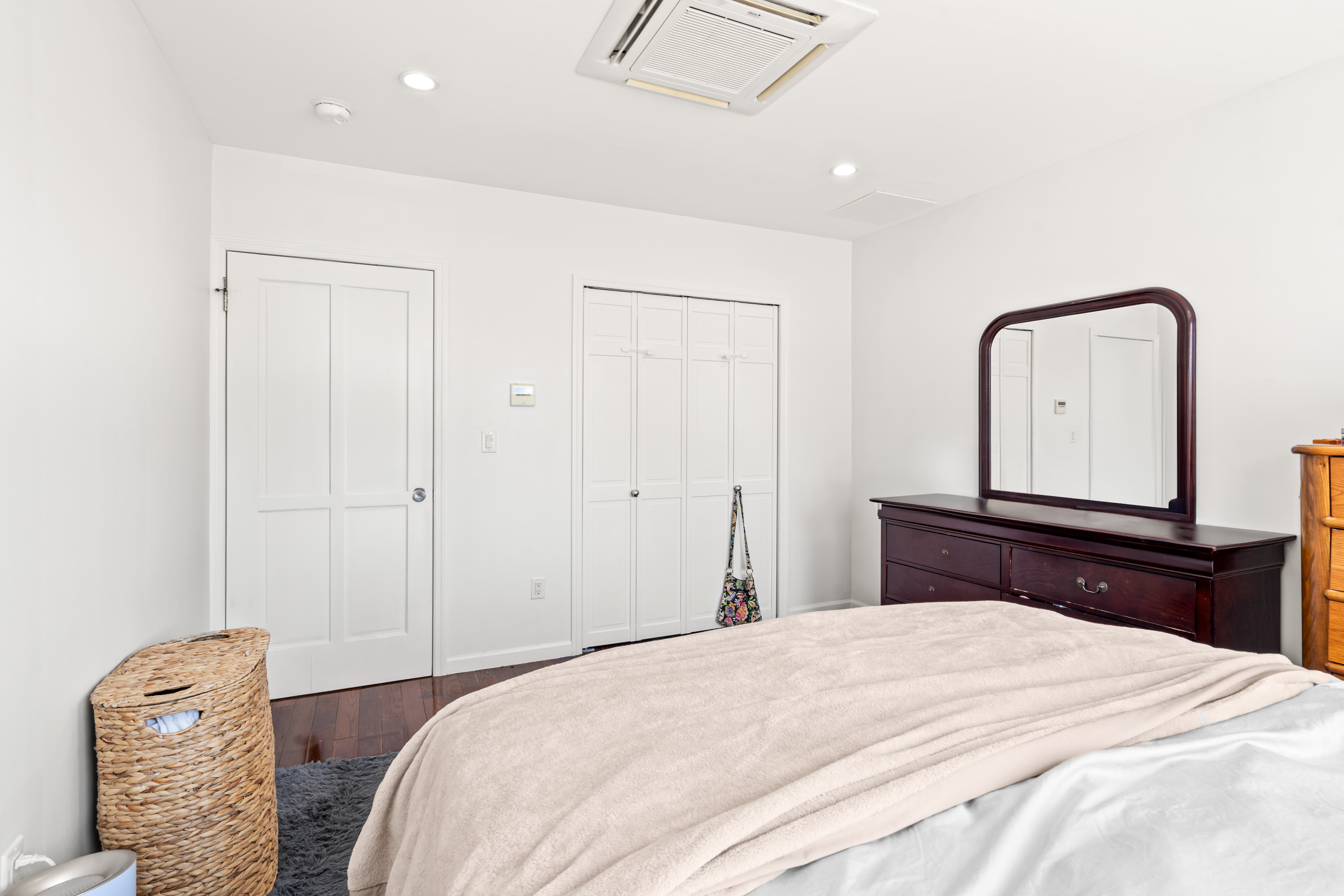 65-33 38th Avenue, Unit 5 Queens, NY 11377 - Photo 8 of 23 a bedroom with a bed and a dresser