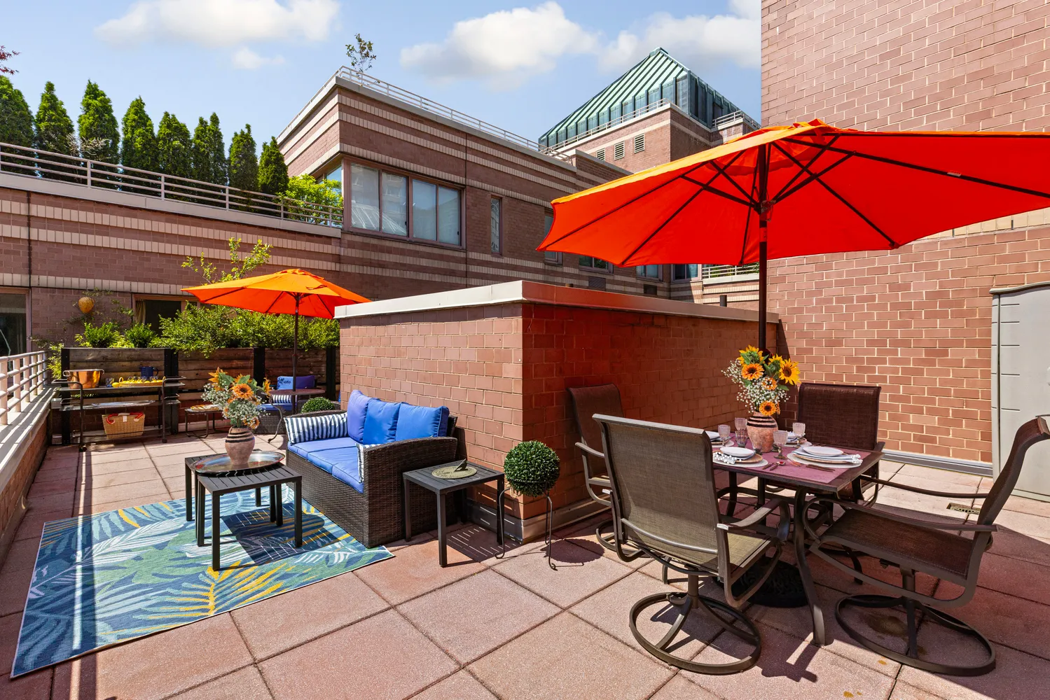 a patio with a table and chairs under an umbrella
