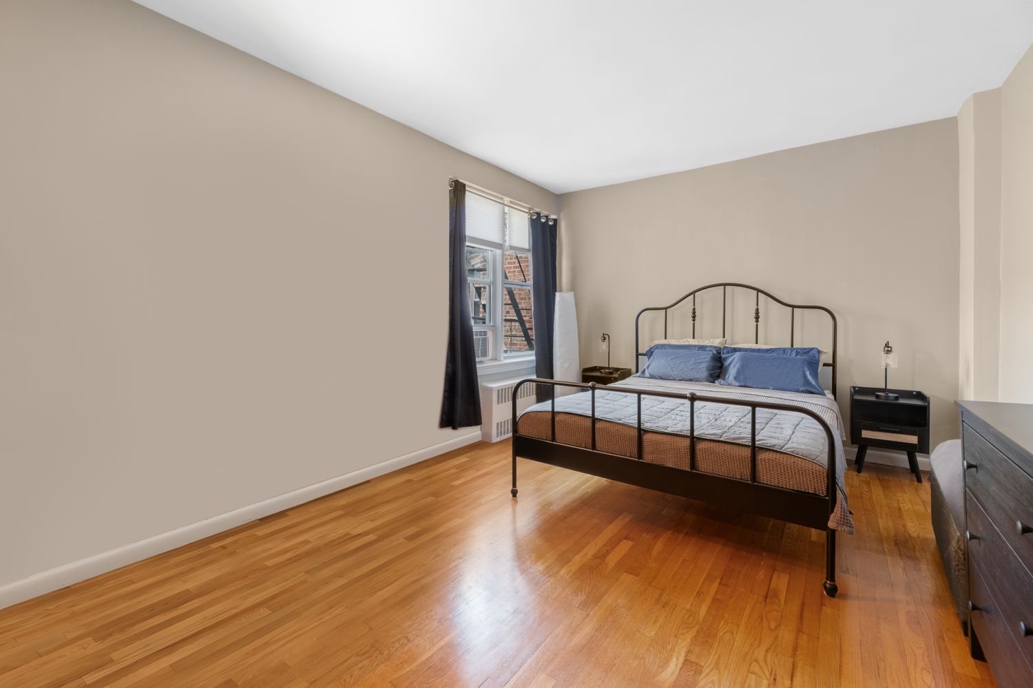 a bedroom with furniture and wooden floor