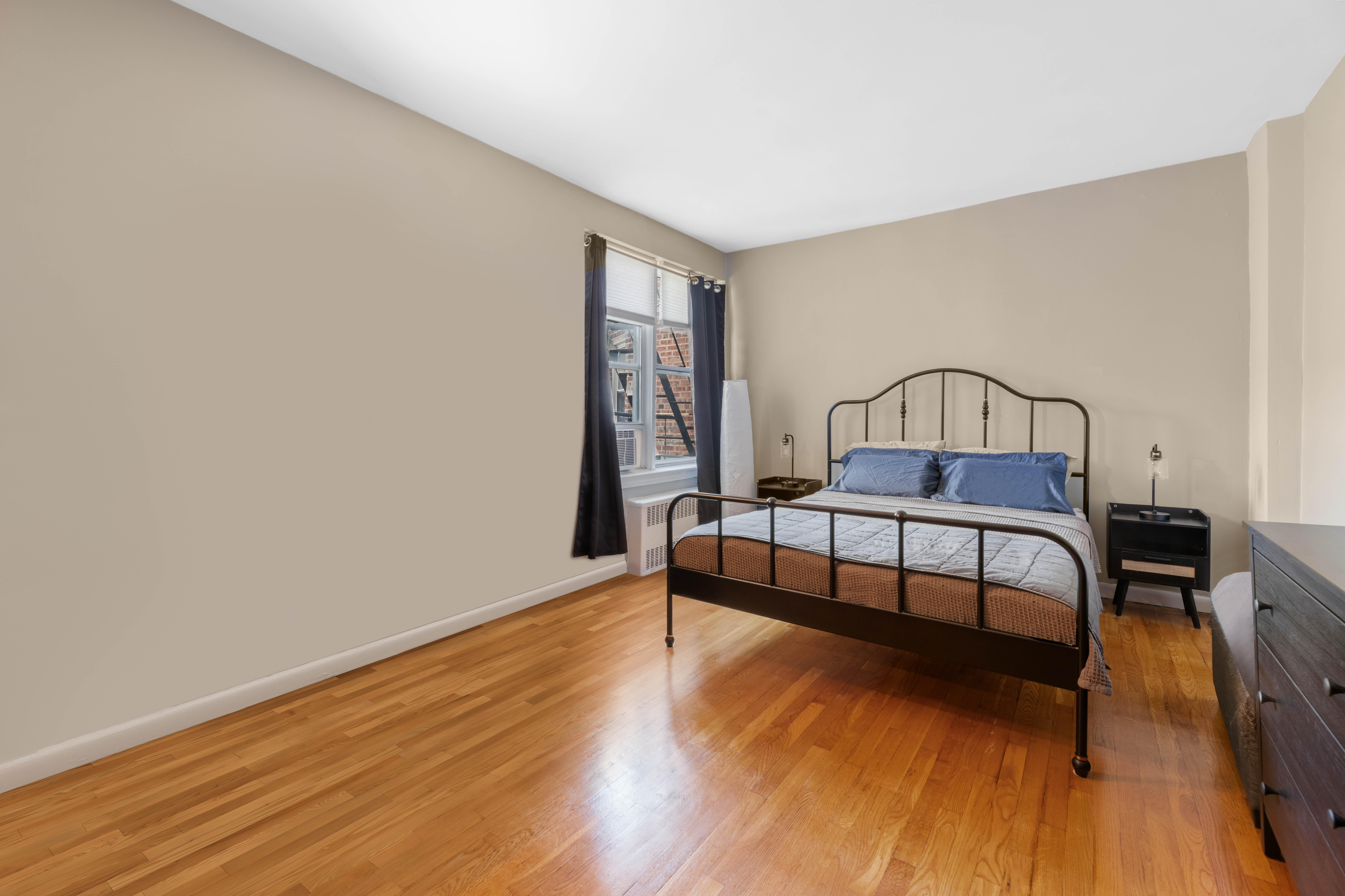 800 Grand Concourse, Unit 5JN Bronx, NY 10451 - Photo 3 of 7 a bedroom with furniture and wooden floor