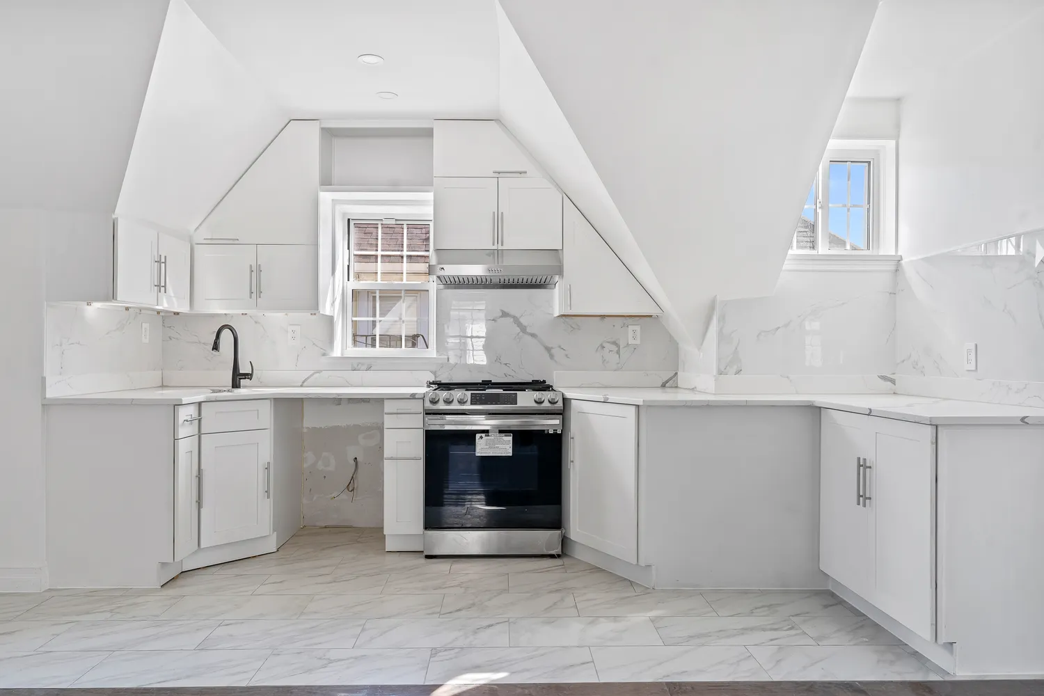 a kitchen with cabinets appliances and a window