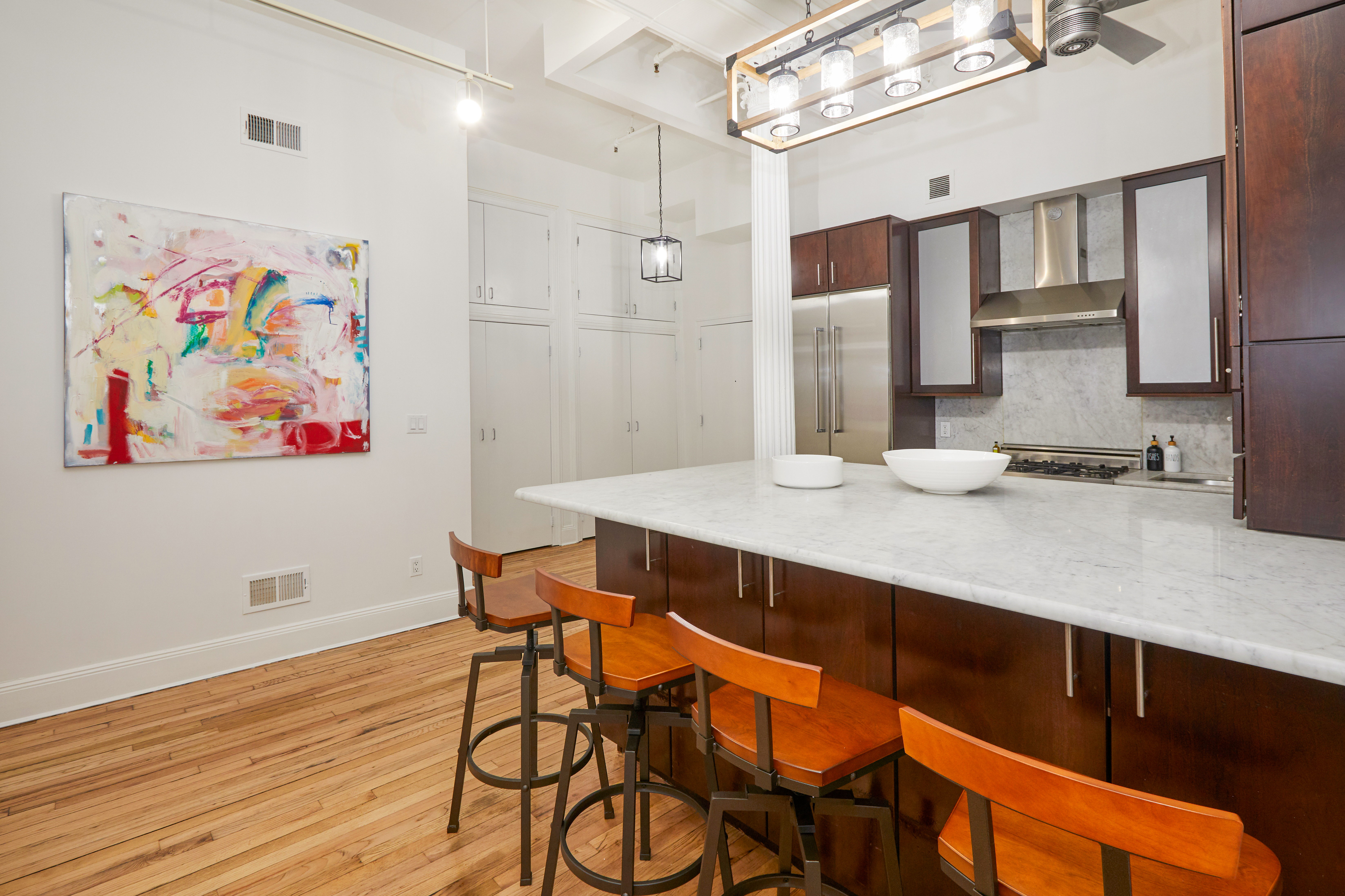 80 Leonard Street, Unit 3G Manhattan, NY 10013 - Photo 13 of 30 a view of kitchen with stainless steel appliances cabinets and wooden floor