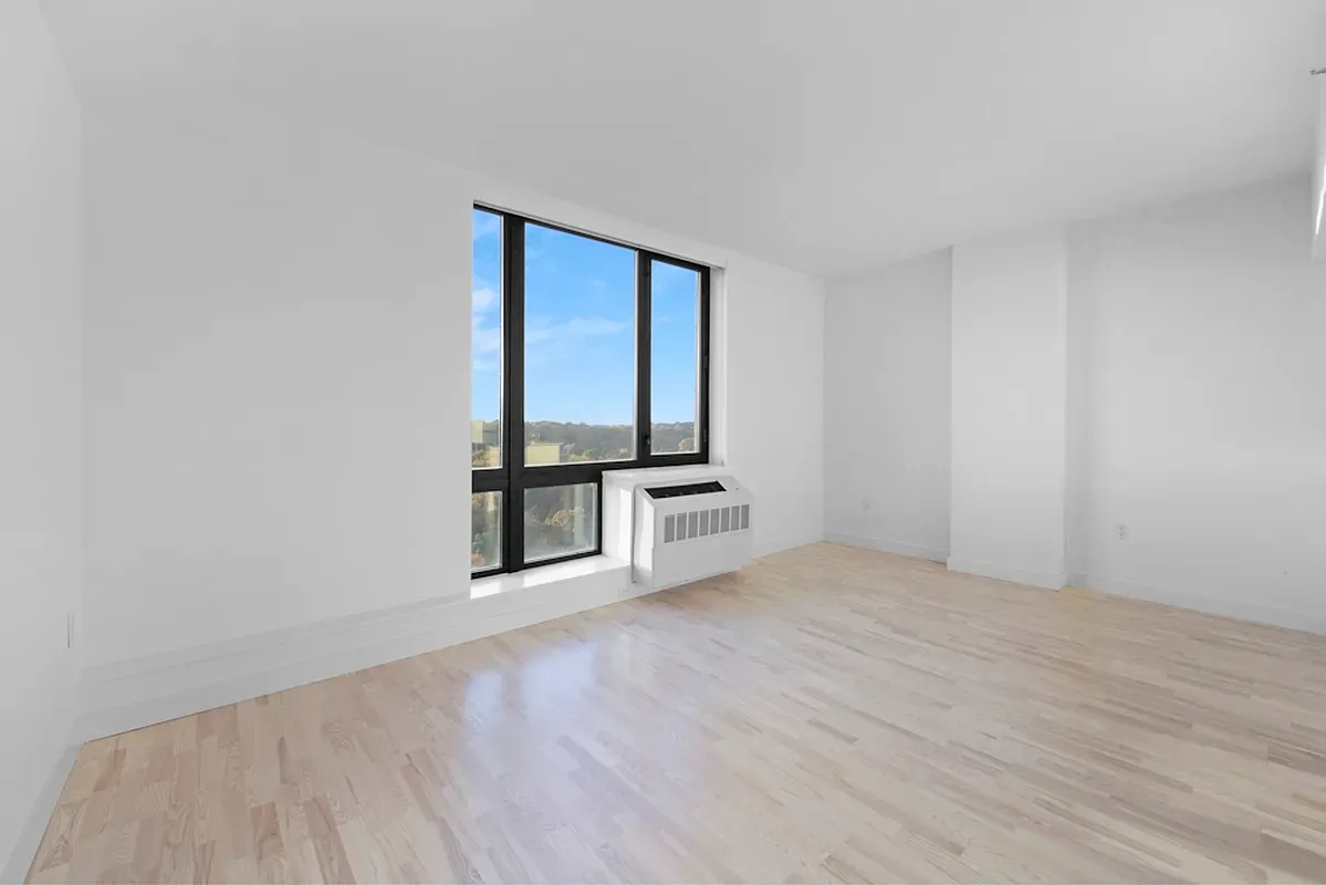 a view of empty room with wooden floor