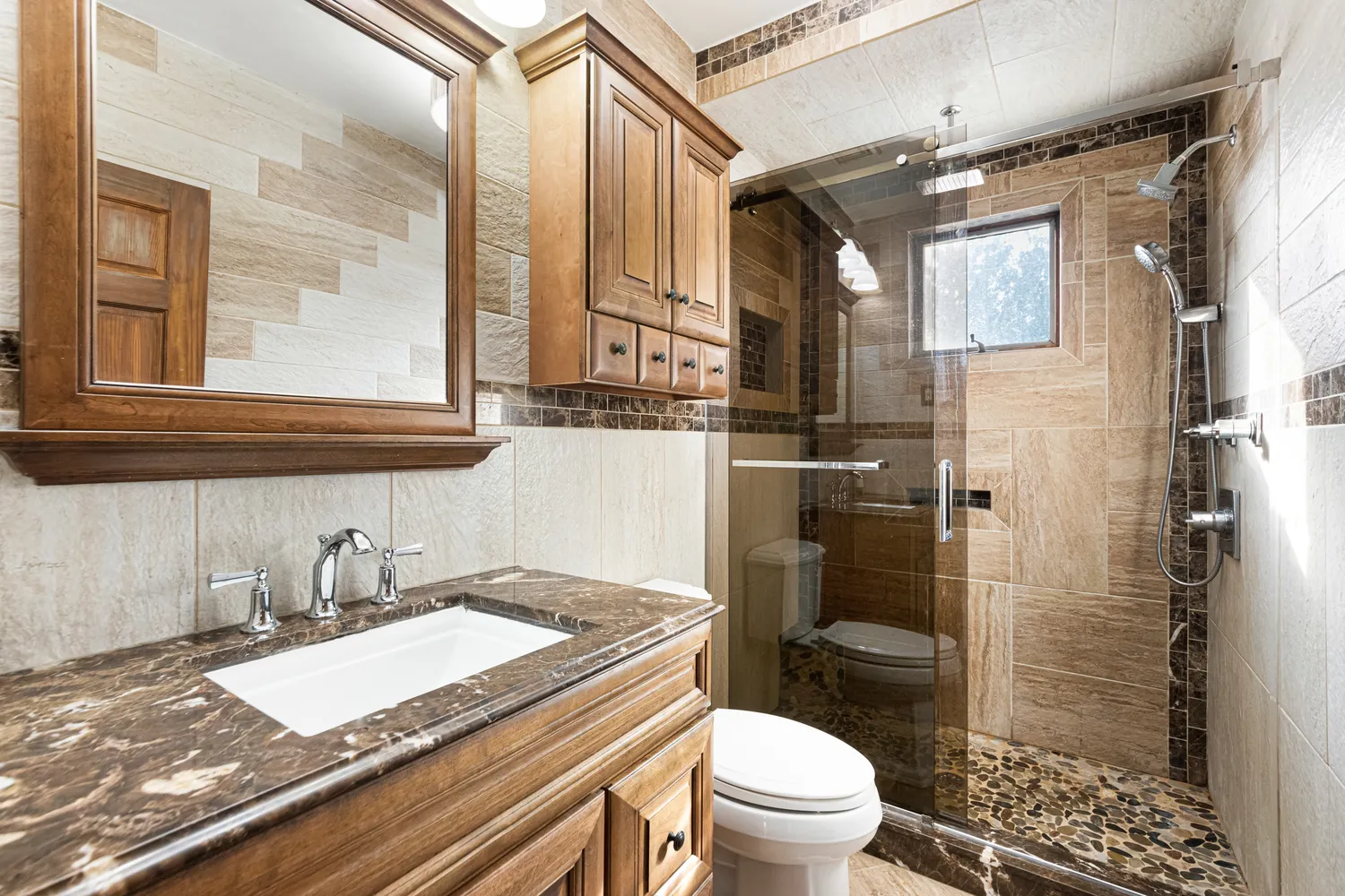 a bathroom with a granite countertop sink toilet and shower