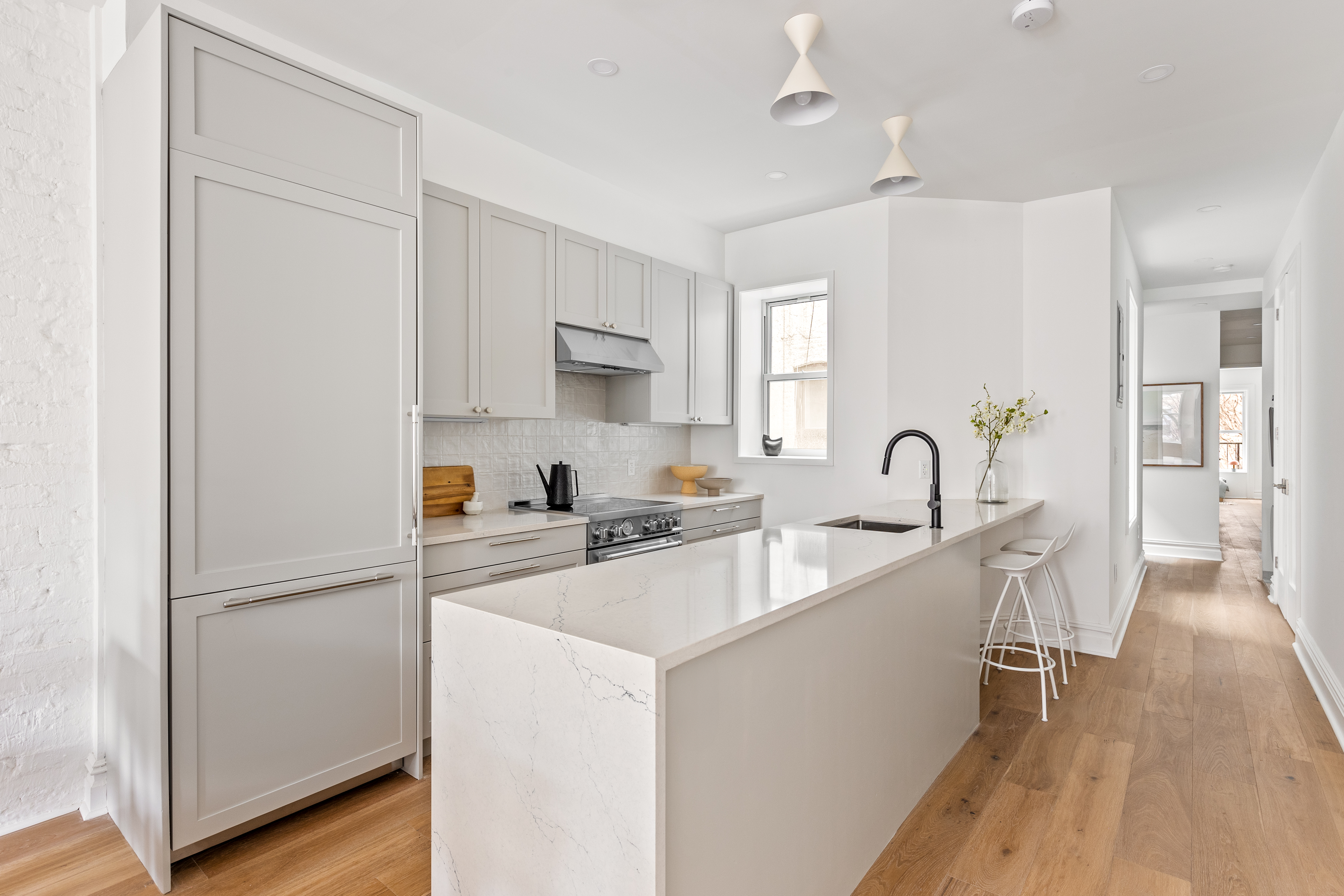 744 Park Place, Unit 3B Brooklyn, NY 11216 - Photo 2 of 10 a kitchen with white cabinets and stainless steel appliances