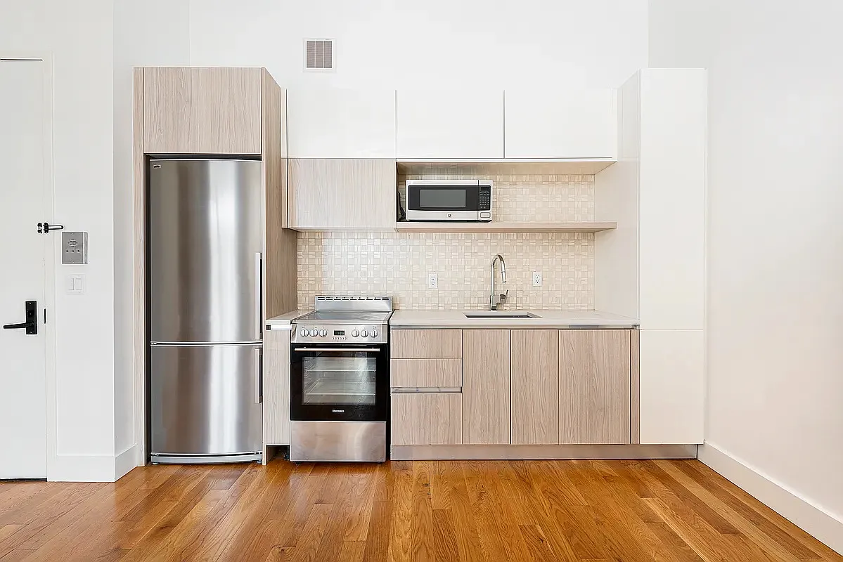 30 Starr Street, Unit 4B Brooklyn, NY 11221 - Photo 3 of 5 a kitchen with stainless steel appliances a refrigerator and a sink