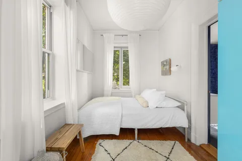 a bedroom with a bed and window