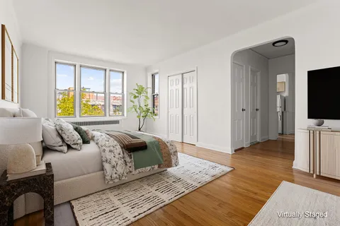 a bedroom with a bed and a flat screen television