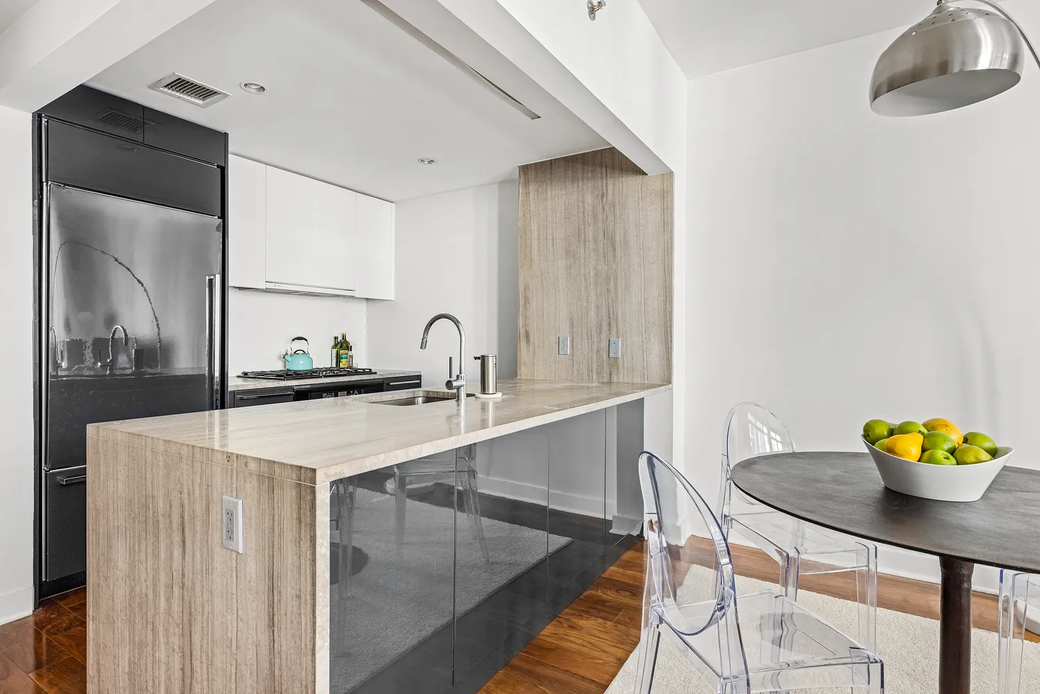 a kitchen with a sink cabinets and a table