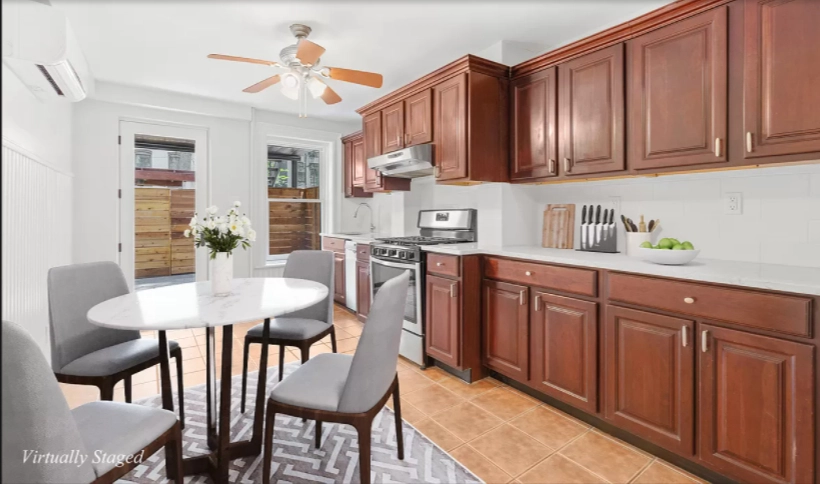 580 Decatur Street, Unit 1 Brooklyn, NY 11233 - Photo 3 of 8 a kitchen with stainless steel appliances kitchen island granite countertop a dining table chairs and a refrigerator