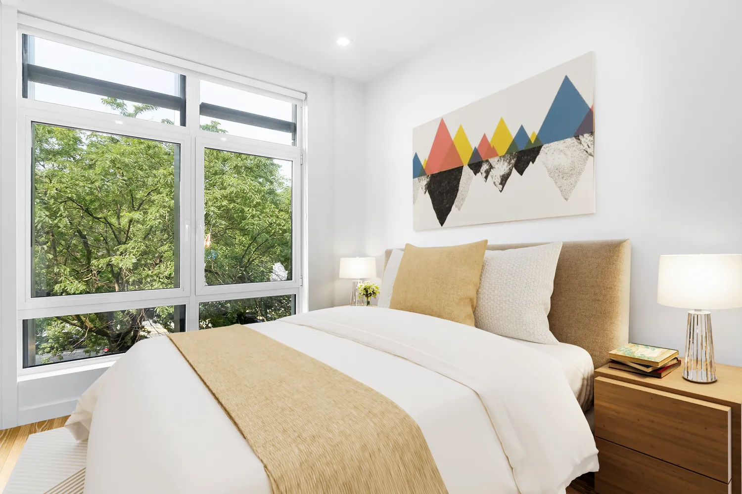 a bedroom with a bed and a large window