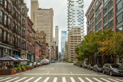 a city street lined with buildings and cars