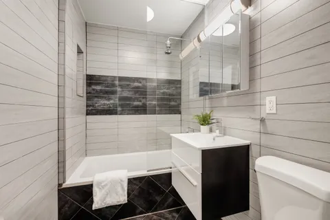 a bathroom with a sink toilet and shower