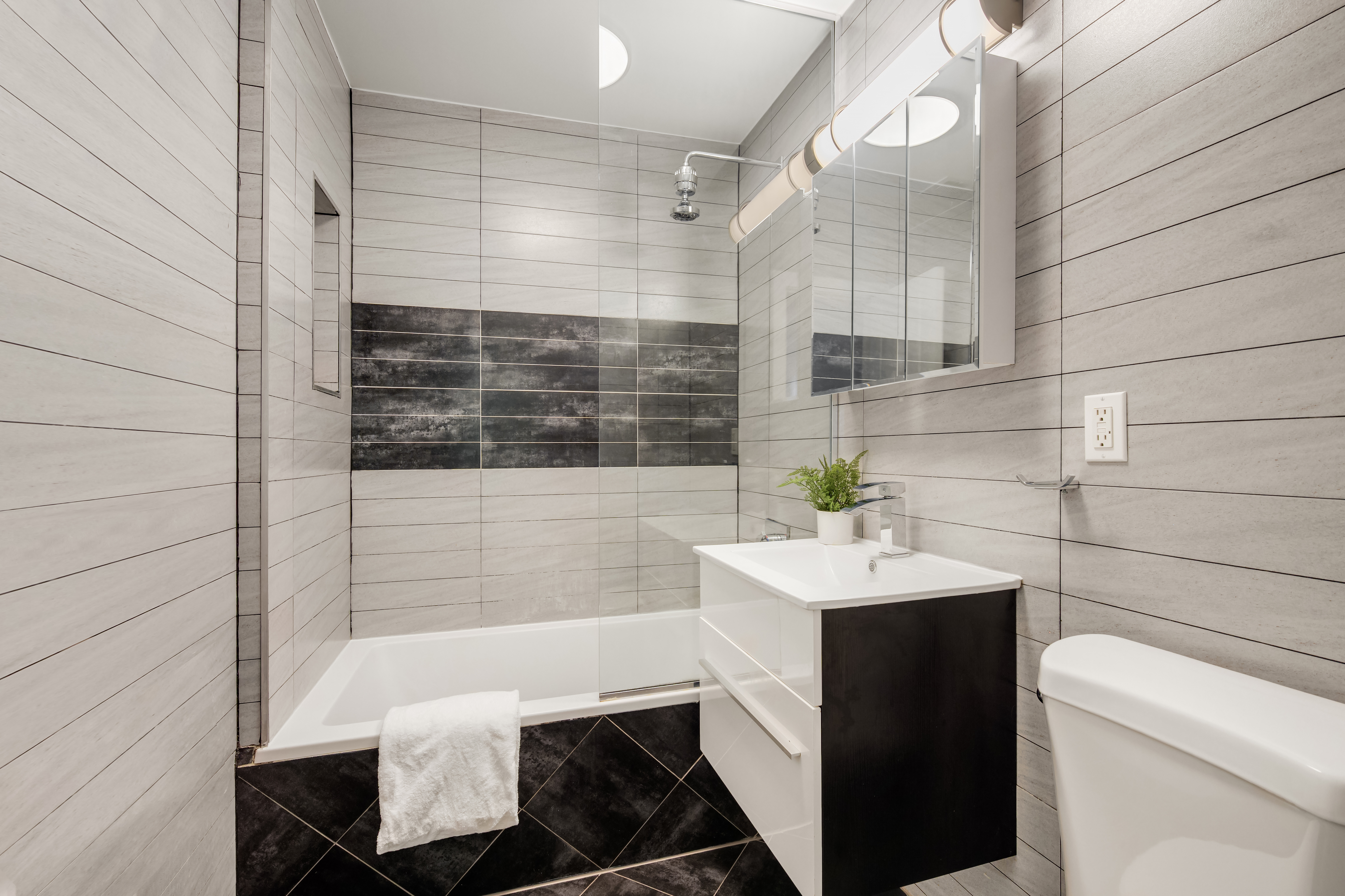 679 Quincy Street, Unit 2 Brooklyn, NY 11221 - Photo 8 of 9 a bathroom with a sink toilet and shower