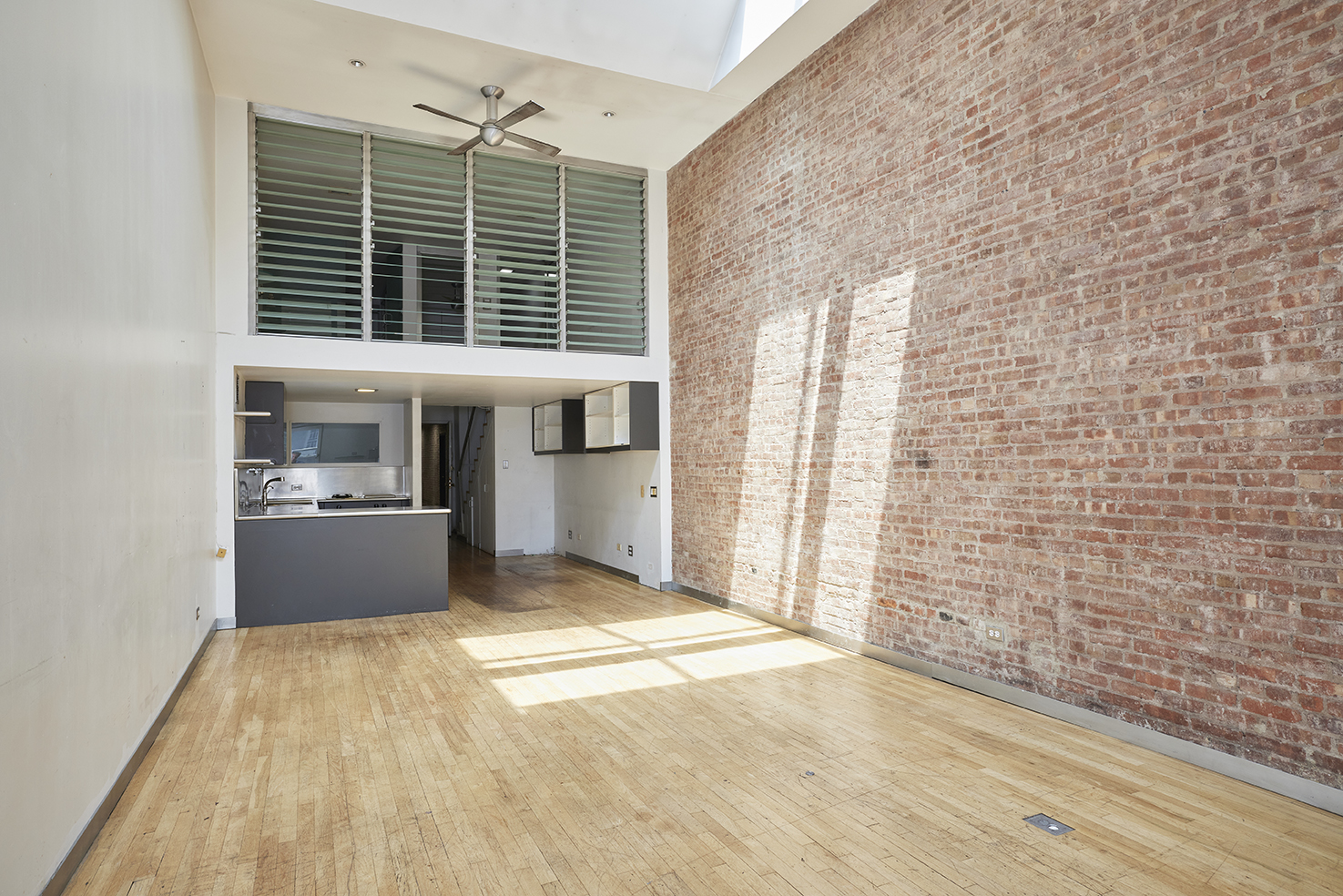 250 Mercer Street, Unit C603 Manhattan, NY 10012 - Photo 3 of 10 a view of an empty room with a window and kitchen view