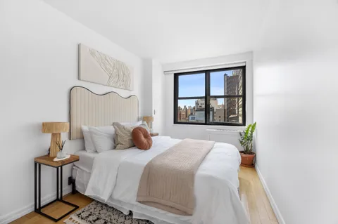 a bedroom with a bed and a window