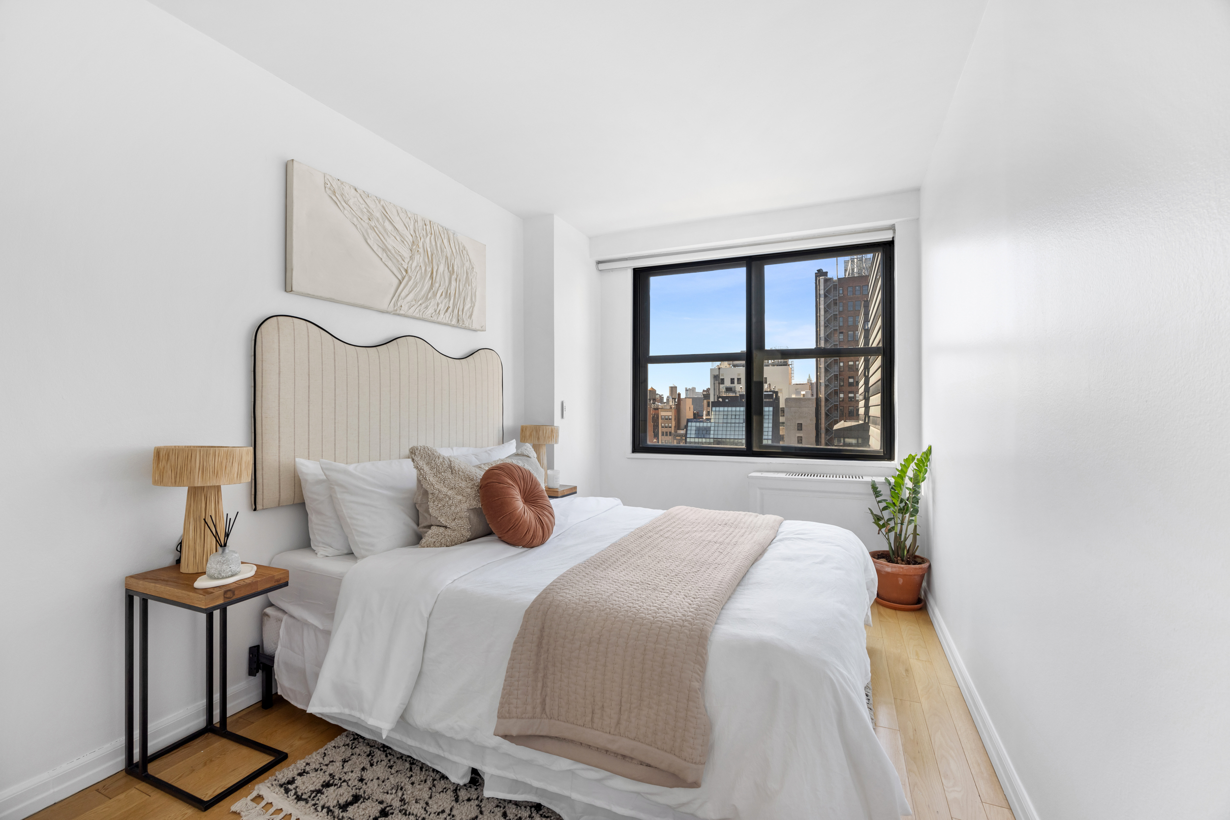 7 East 14th Street, Unit 17G Manhattan, NY 10003 - Photo 5 of 8 a bedroom with a bed and a window