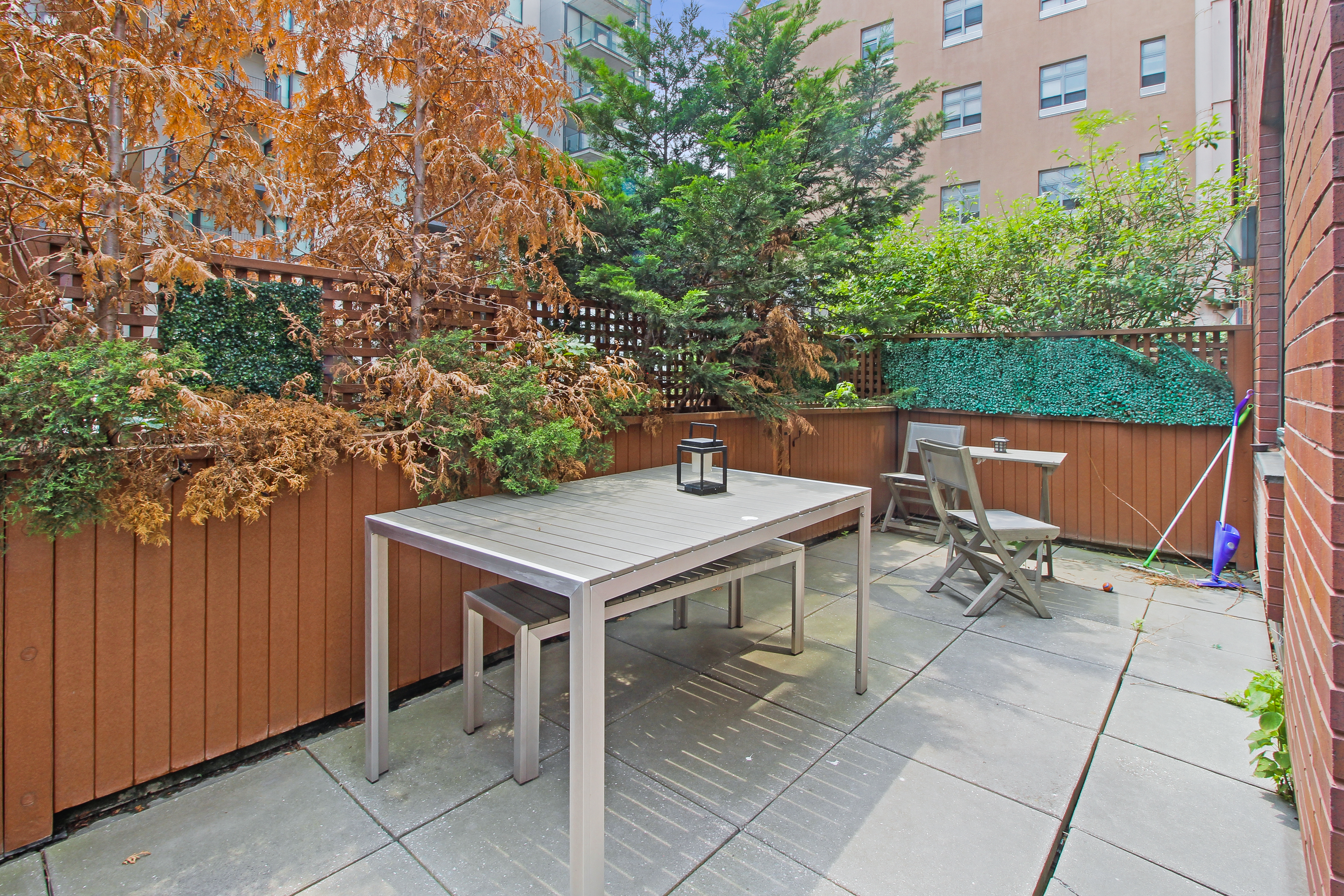 199 Bowery, Unit 2B Manhattan, NY 10002 - Photo 6 of 12 a backyard of a house with table and chairs