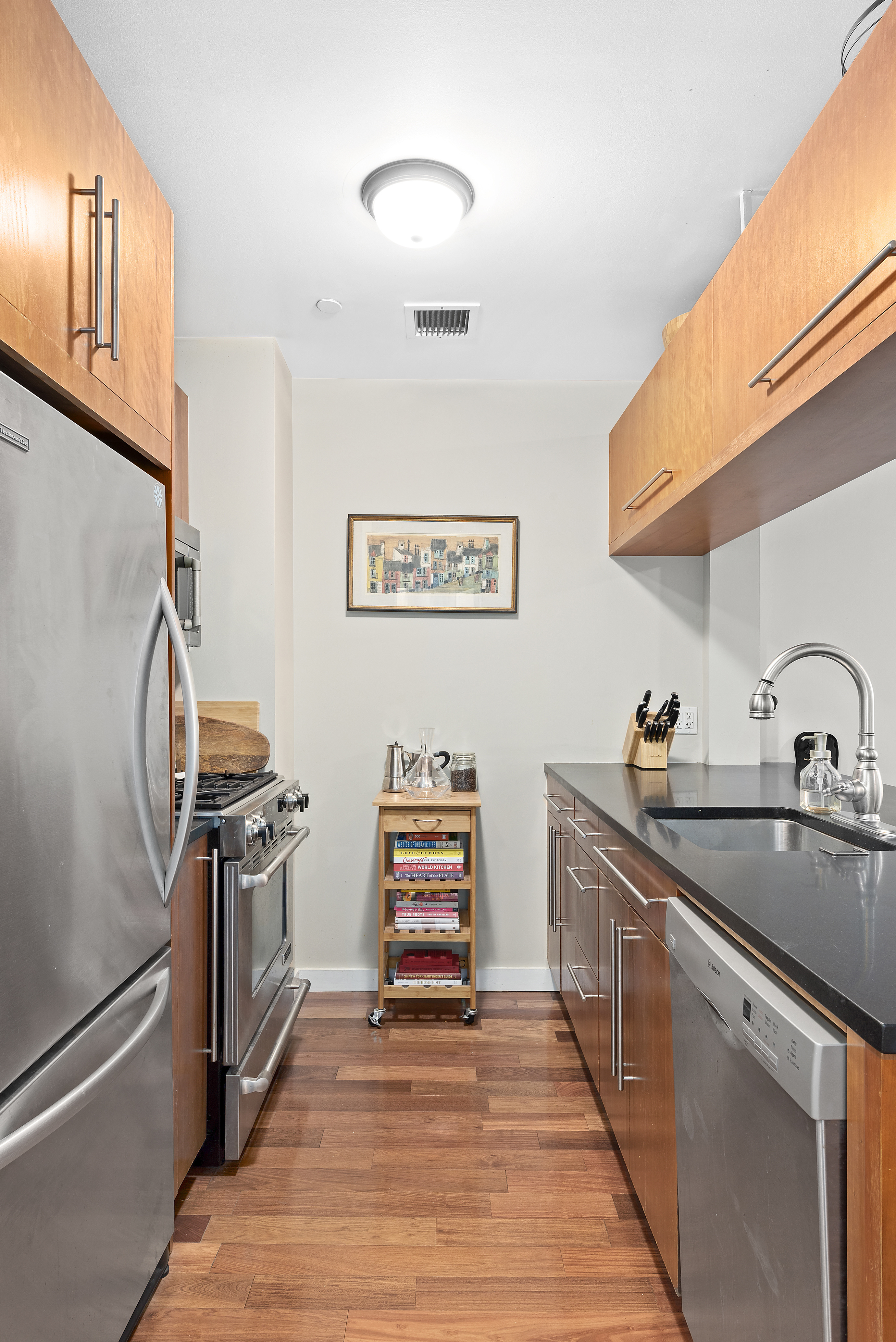 2-40 51st Avenue, Unit 2N Queens, NY 11101 - Photo 2 of 10 a kitchen with stainless steel appliances granite countertop a stove and a sink