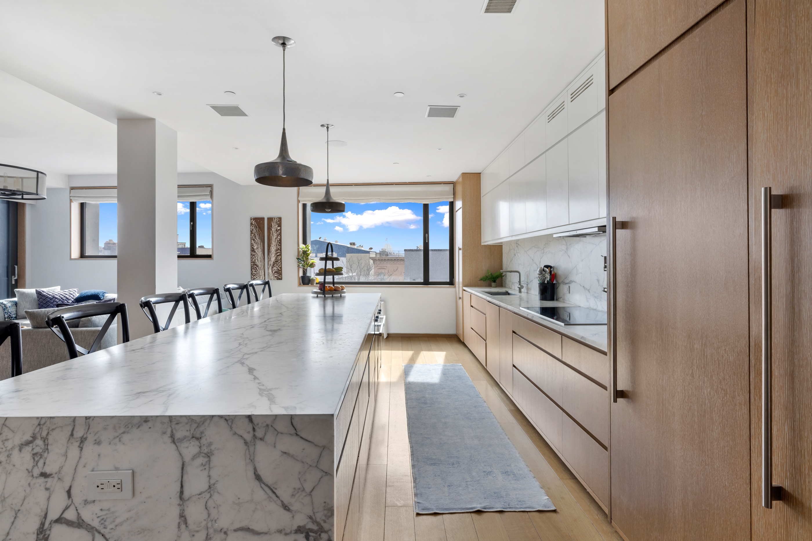 210 Pacific Street, Unit 6 Brooklyn, NY 11201 - Photo 8 of 20 a view of a kitchen with kitchen island a large counter space a sink appliances and cabinets