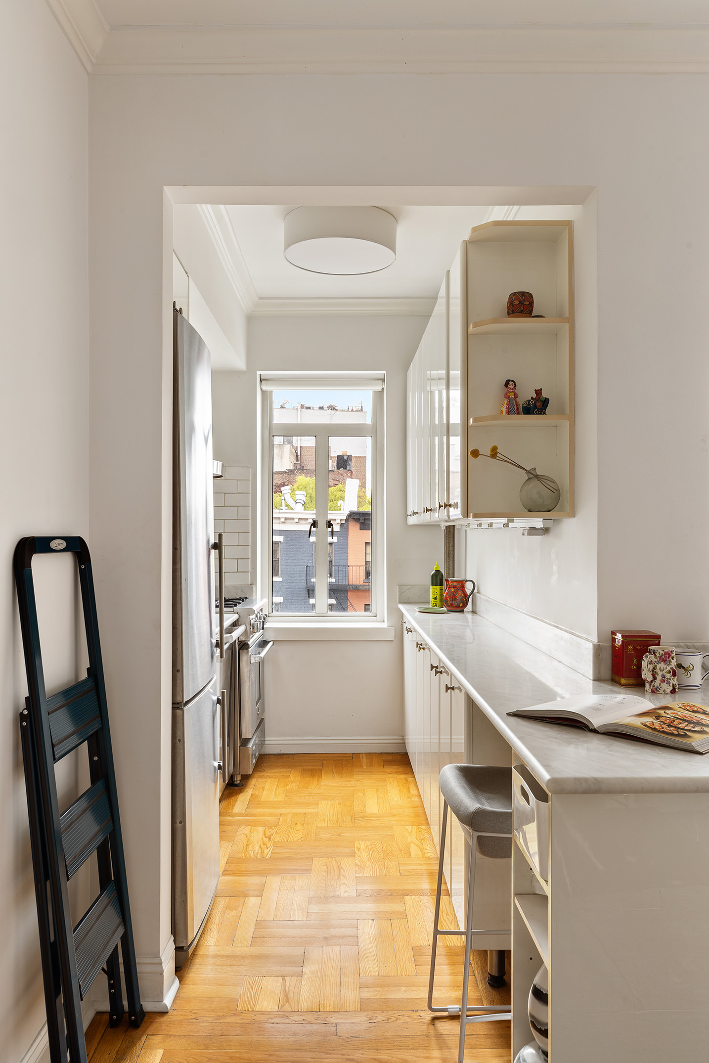 165 West 20th Street, Unit 4K Manhattan, NY 10011 - Photo 3 of 7 a large white kitchen with a window
