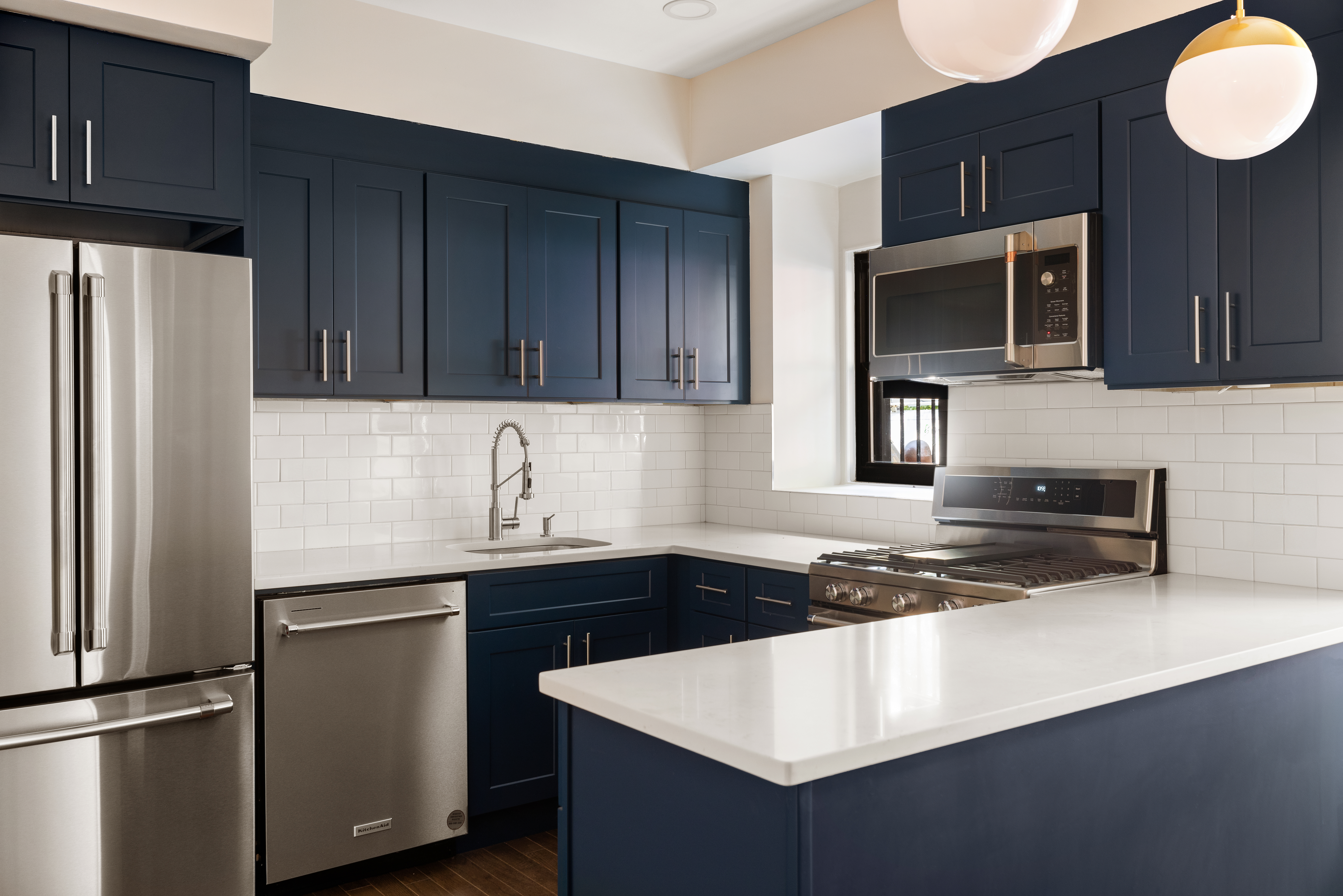 280 Clinton Street, Unit 1 Brooklyn, NY 11201 - Photo 4 of 11 a kitchen with stainless steel appliances a sink a stove a microwave and refrigerator