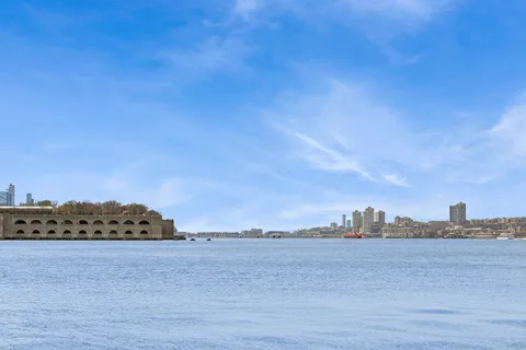 a view of a large body of water and mountain in back