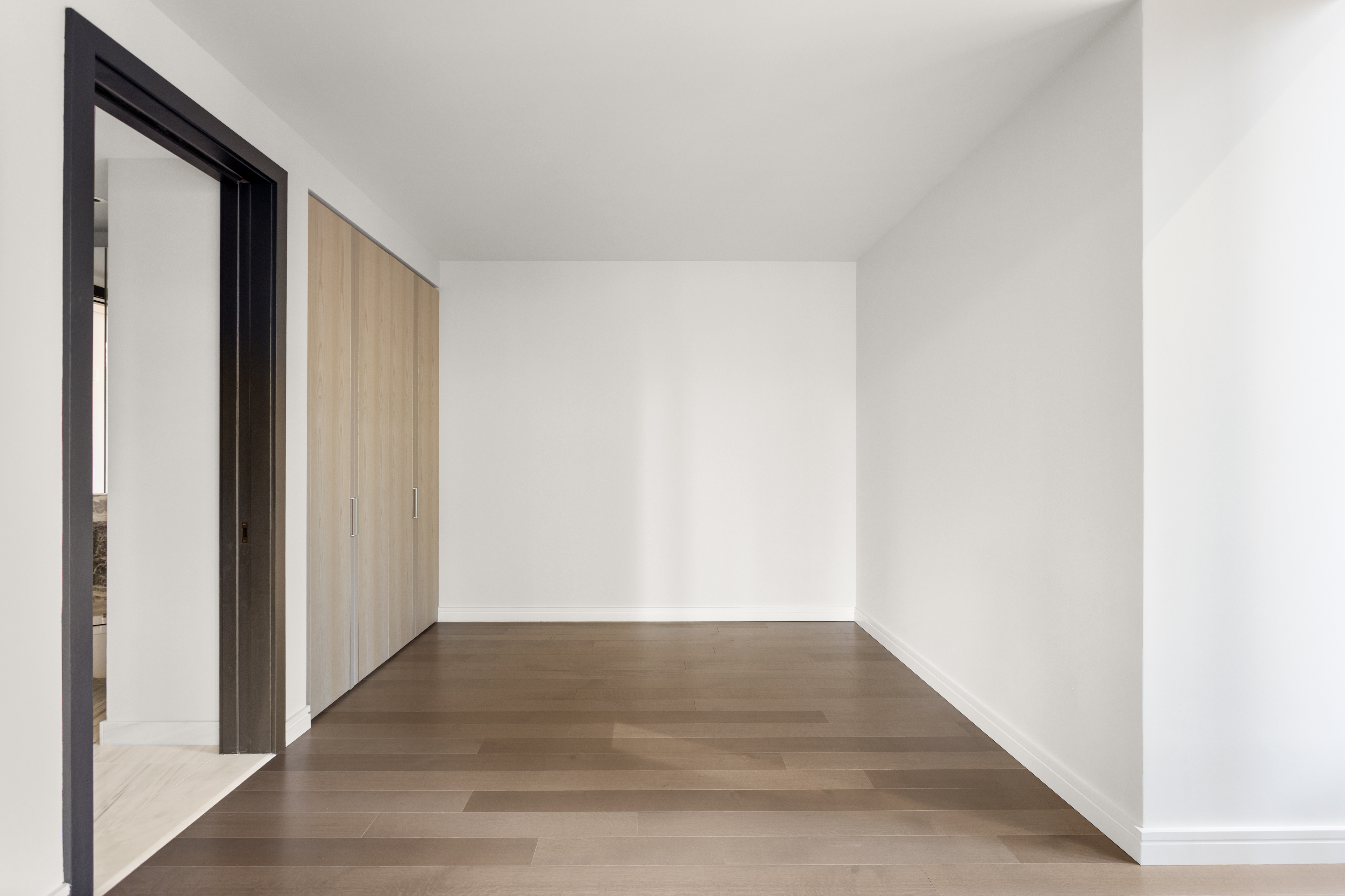 125 Greenwich Street, Unit 31A Manhattan, NY 10006 - Photo 15 of 23 a view of a hallway with wooden floor