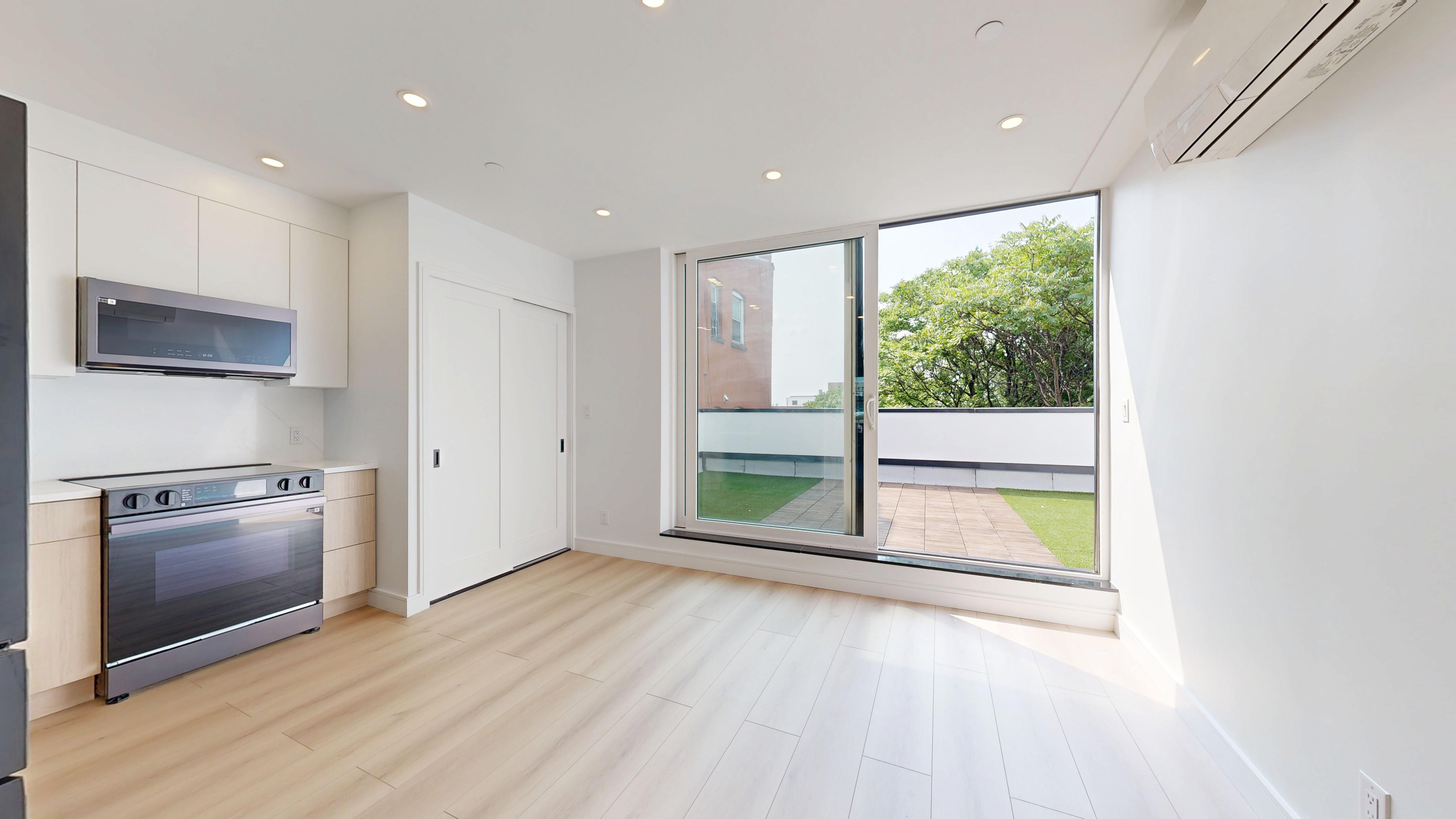 5614 3rd Avenue, Unit 3 Brooklyn, NY 11220 - Photo 7 of 11 a view of a kitchen with a sink and a stove top oven