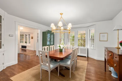 a view of a dining room with furniture wooden floor and chandelier