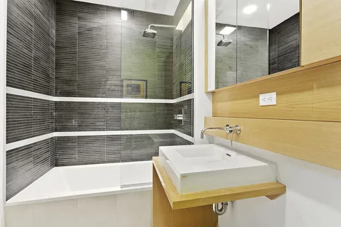 a bathroom with a bathtub and shower