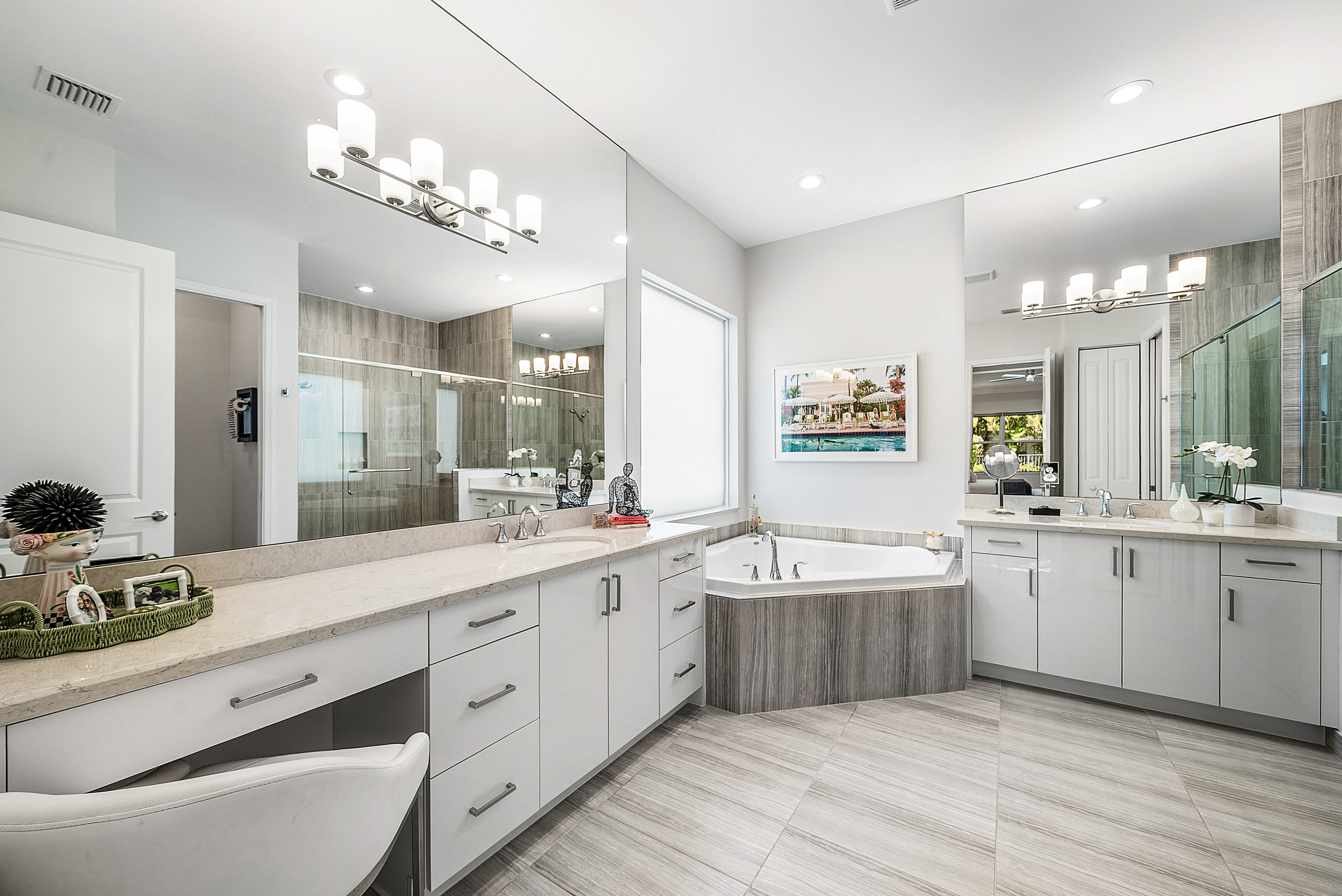 13172 Whistler Mountain Road Delray Beach, FL 33446 - Photo 18 of 38 a large white kitchen with cabinets a sink dishwasher and a dining table with wooden floor