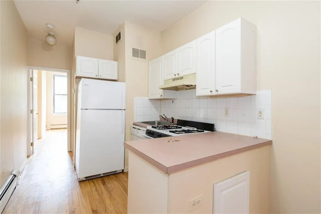 a kitchen with a stove a refrigerator and a sink