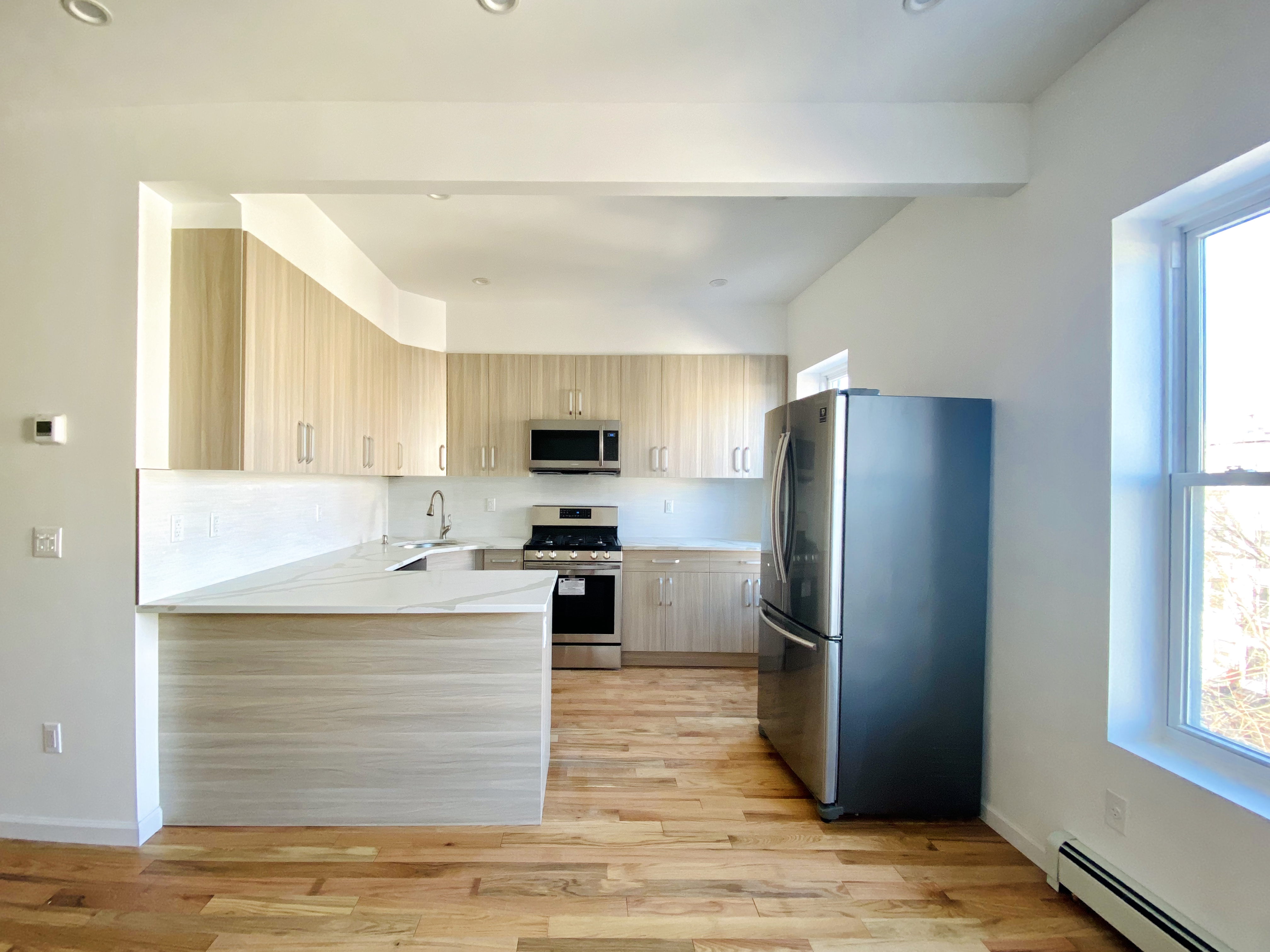 175 Luquer Street, Unit 4 Brooklyn, NY 11231 - Photo 14 of 21 a kitchen with a refrigerator an oven a sink and a window