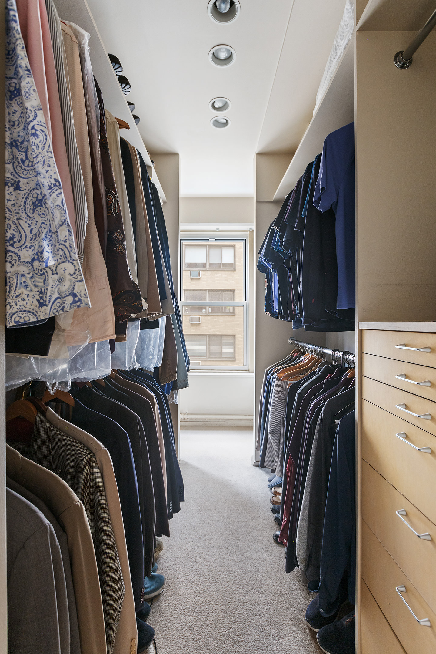 25 West 15th Street, Unit 3 Manhattan, NY 10011 - Photo 15 of 19 a view of walk in closet with clothes and shoes