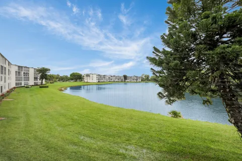 a view of a lake with houses in the back