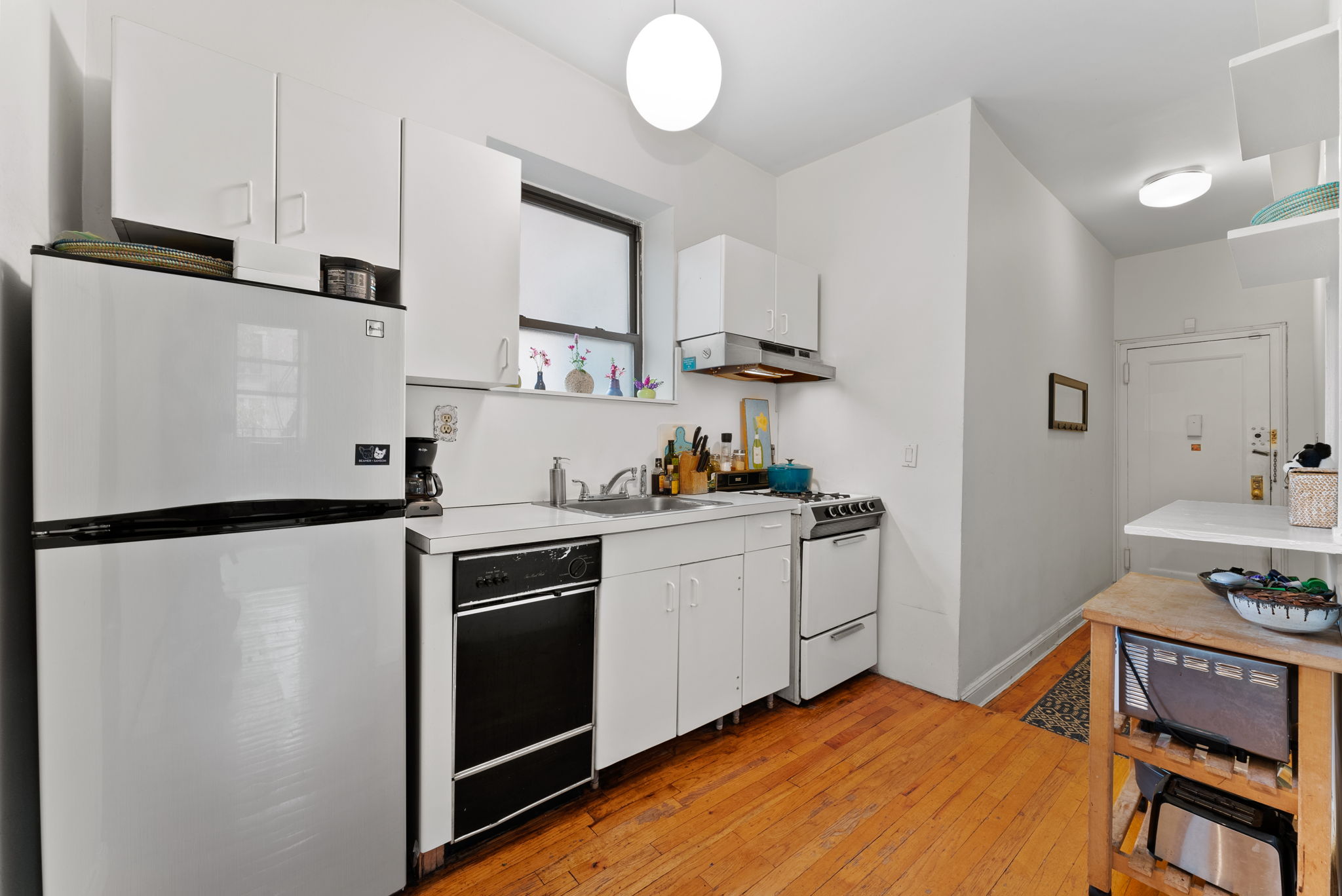 311 Henry Street, Unit 3 Brooklyn, NY 11201 - Photo 6 of 10 a kitchen with stainless steel appliances a refrigerator sink and cabinets