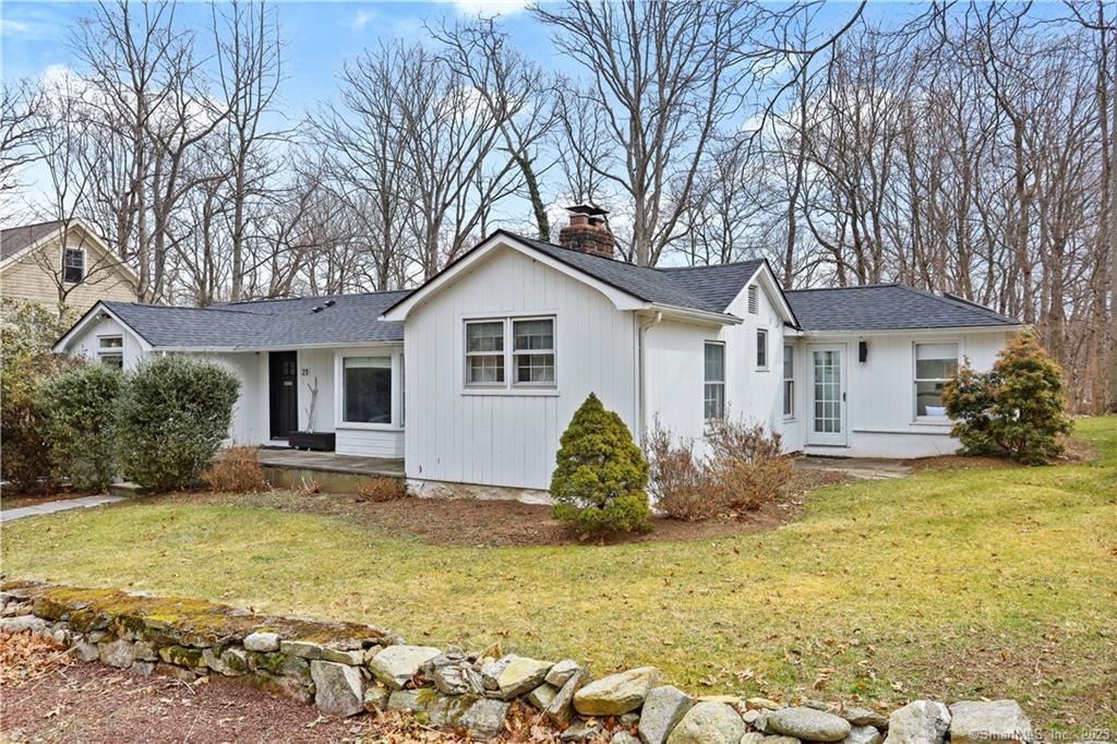 21 Rayfield Road Westport, CT 06880 - Photo 2 of 3 a front view of a house with garden