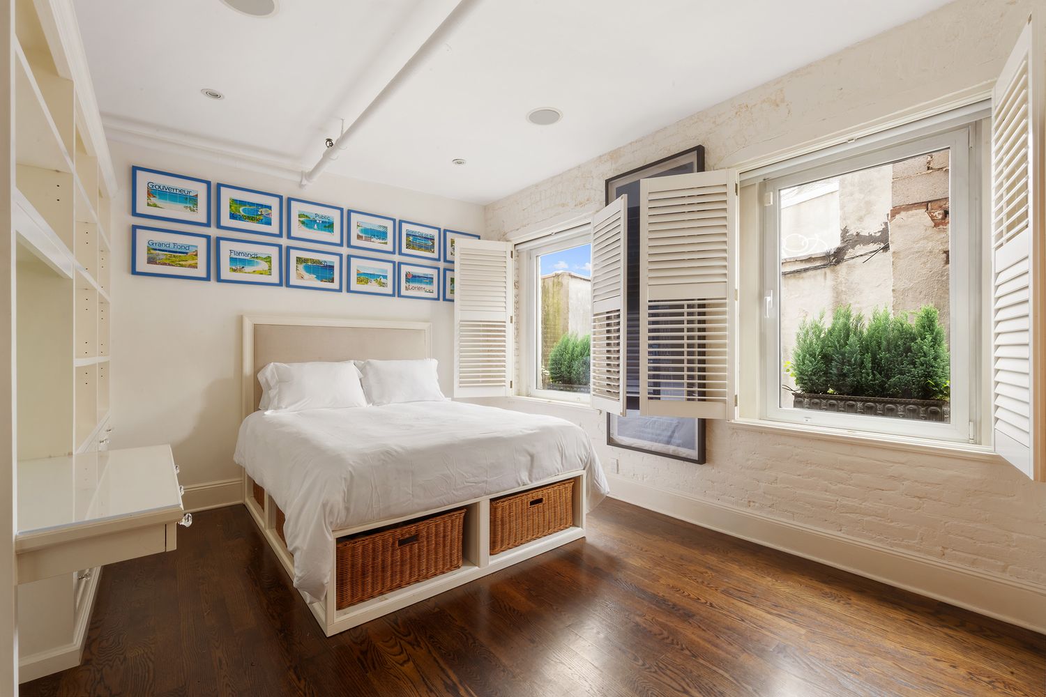 a bedroom with a bed and a large window with outer view