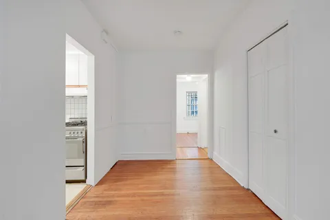 a view of hallway with wooden floor