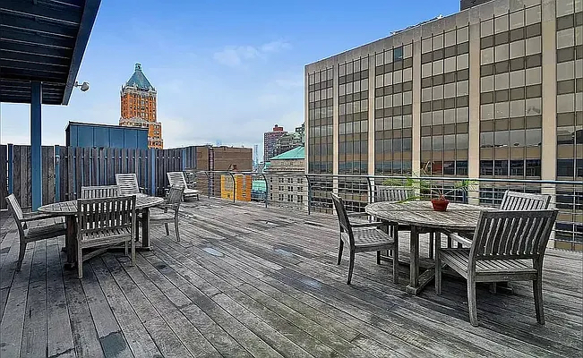 110 Livingston Street, Unit 10K Brooklyn, NY 11201 - Photo 7 of 10 a view of a roof deck with table and chairs and wooden floor