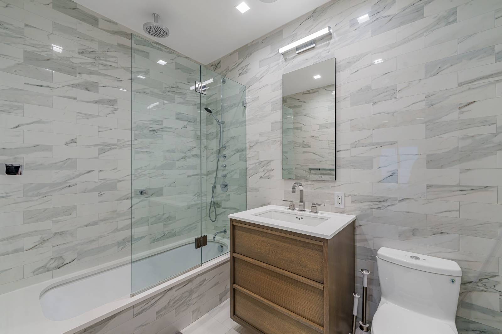 124 East 13th Street, Unit 3 Manhattan, NY 10003 - Photo 13 of 26 a bathroom with a sink mirror toilet and bathtub